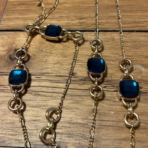 Long gold necklace with blue gems